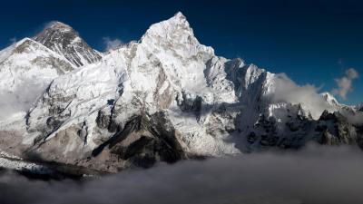 Mount Everest in the Everest Range of the Himalayas in Nepal. Everest is the peak to the left of the picture with snow blowing off its top. Mount Everest in the Everest Range of the Himalayas in Nepal. Everest is the peak to the left of the picture with snow blowing off its top.