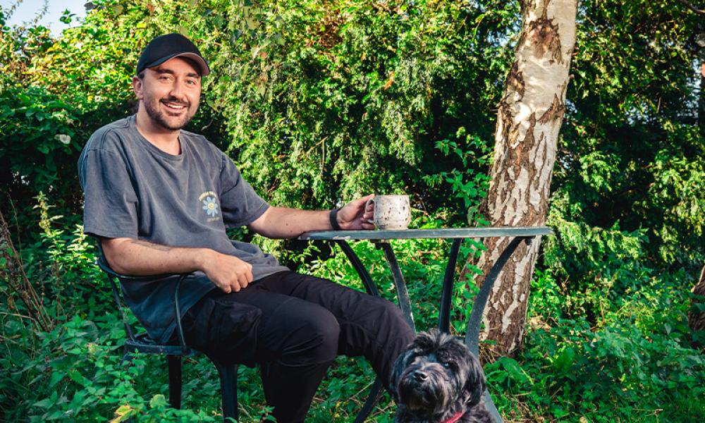 Conor McDonnell and his dog having a cup of tea in the garden
