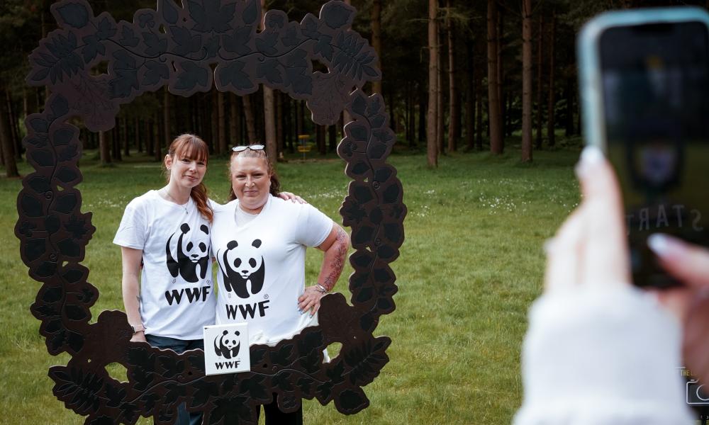 2 people taking a photo in WWF nature frame