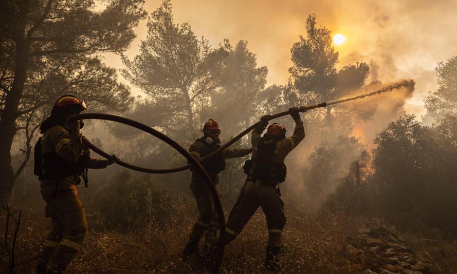 Firefighters battle a wildfire in Agia Sotira, a western suberb of Athens, Greece, on July 20, 2023.