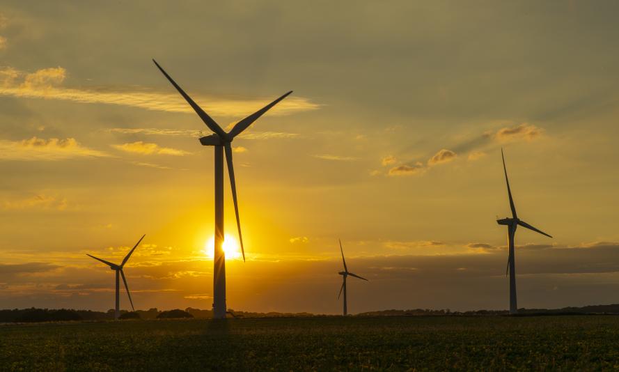 Wind turbines in Norfolk with sun setting behind